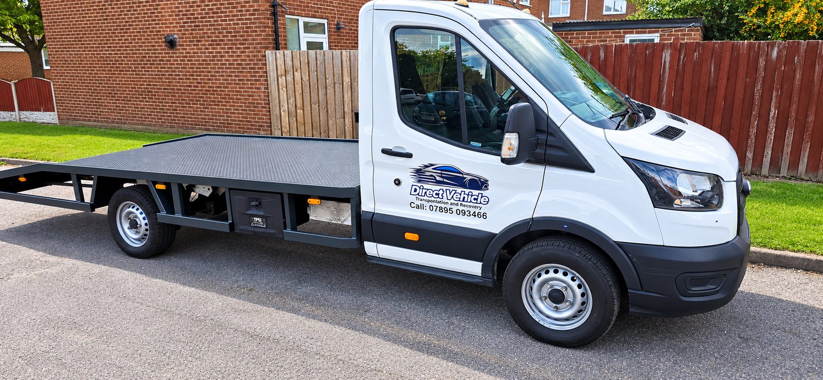 Direct Vehicle branded white transporter with a flatbed deck